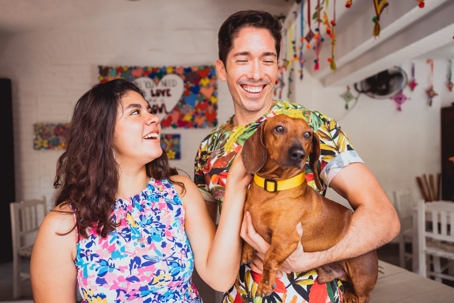 Marcus and Jamie, an unmarried couple in Texas, pose with their dachshund Biscuit while discussing legal protections for partners and families.
