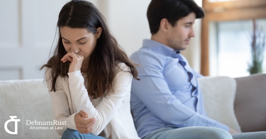 man and woman facing away from each other upset