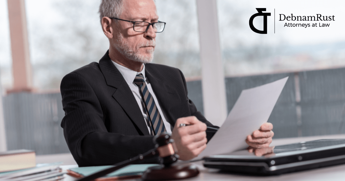man in suit looking at document with gavel in front of him